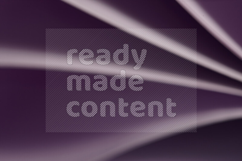 An abstract art showing purple paper sheets arranged in an overlapping curves