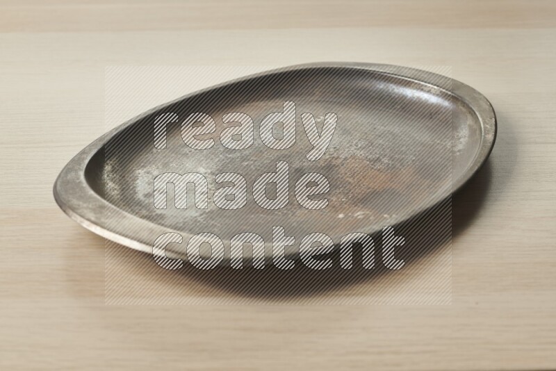 A vintage metal tray on light wooden background