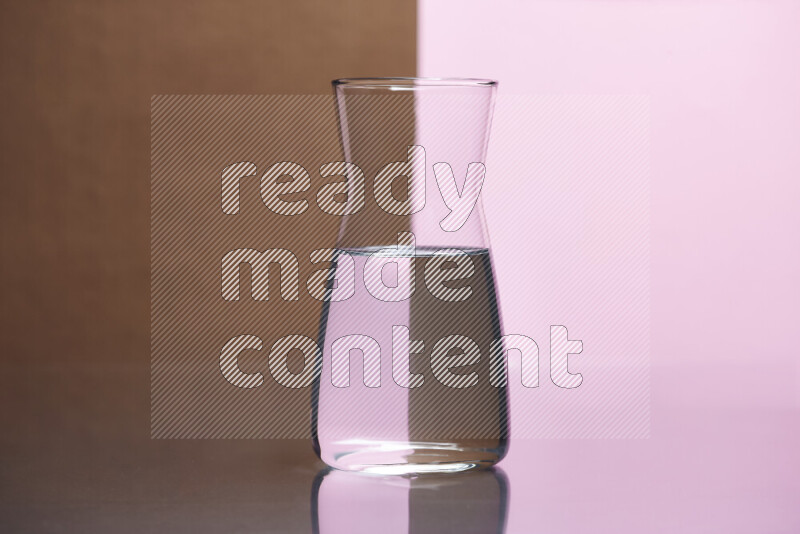 The image features a clear glassware filled with water, set against brown and rose background