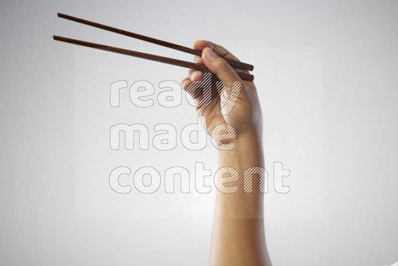 Male Hand Holding Chop Stick on white background