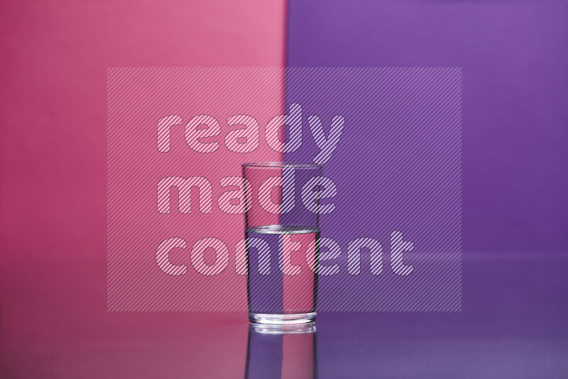 The image features a clear glassware filled with water set against pink and purple background