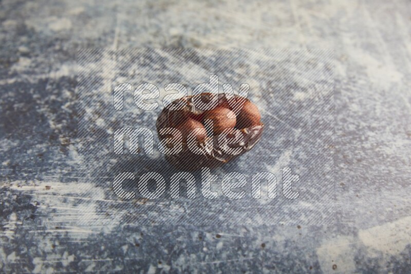 hazelnuts stuffed majdoul date on a rustic blue background