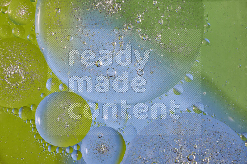 Close-ups of abstract oil bubbles on water surface in shades of green and blue