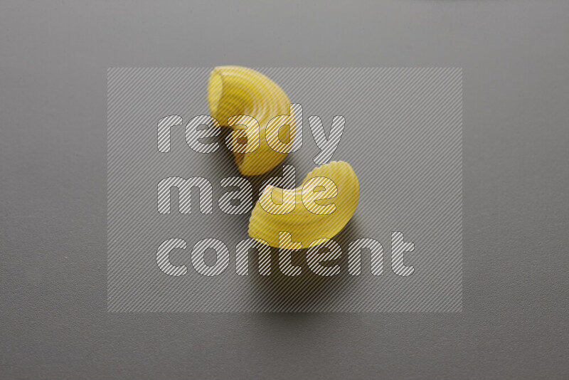 Elbow pasta on grey background