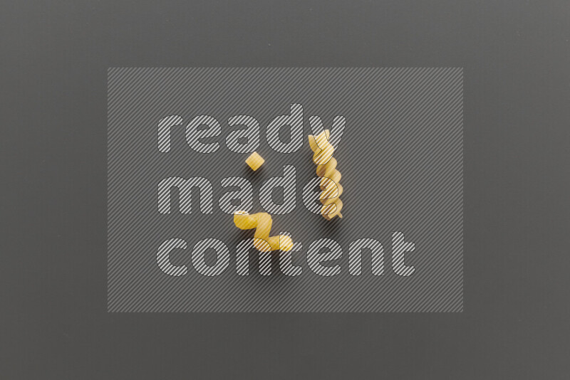Different pasta types on grey background