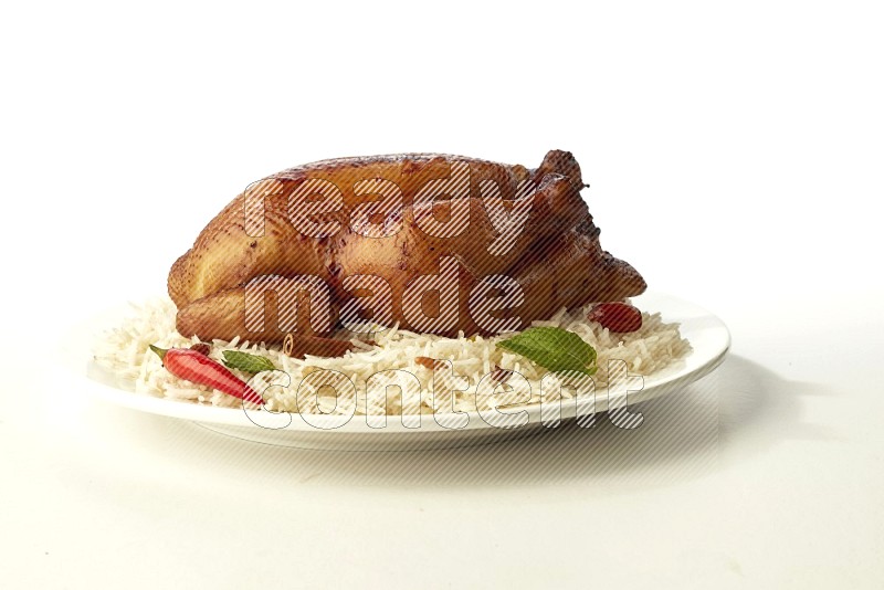 white  basmati Rice with  whole roasted chicken  on a white rounded plate direct on white background