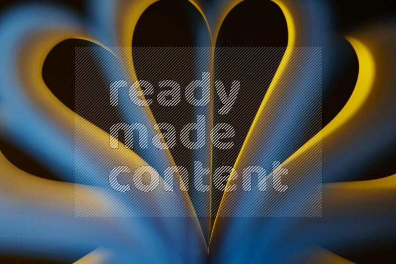 فن تجريدي يعرض منحنيات وتدرجات اللون الأصفر والأزرق مكونه بضوء ملون