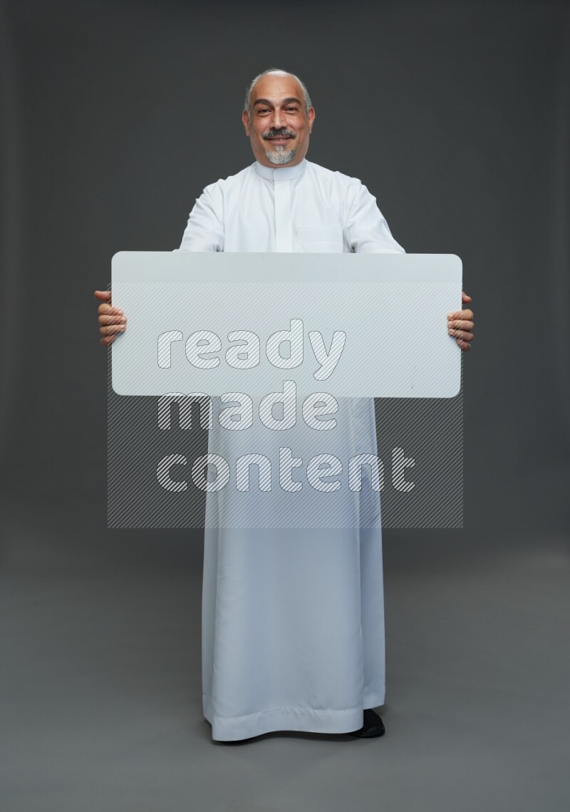 Saudi man without shomag Standing holding social media sing on gray background
