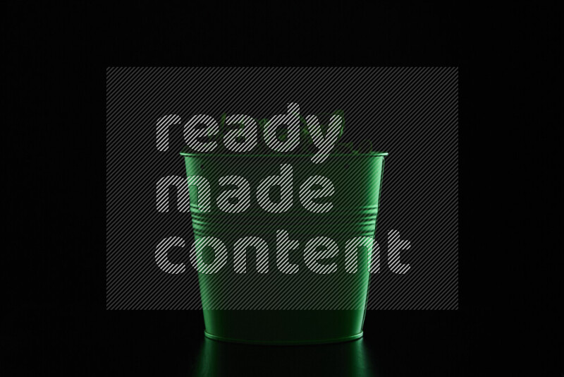 A plant pot with colored rim light against black background