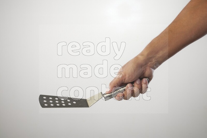 Male Hand Holding Burger Flipper on white background