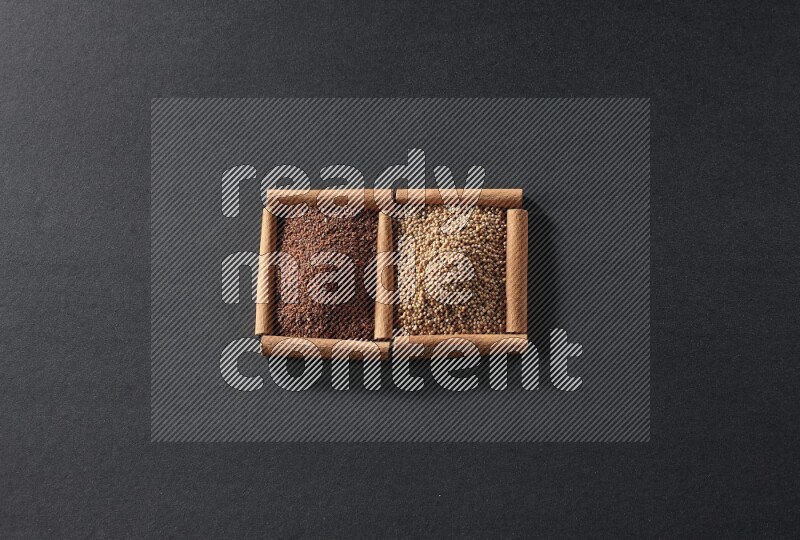 مربعان من أعواد القرفة ممتلئان بحبوب الخردل وحب الرشاد علي خلفية سوداء