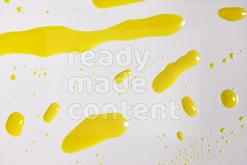 Close-ups of abstract yellow paint droplets on white background