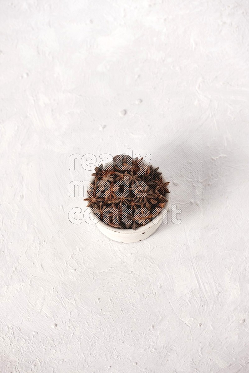 Star Anise in a white bowl on white background