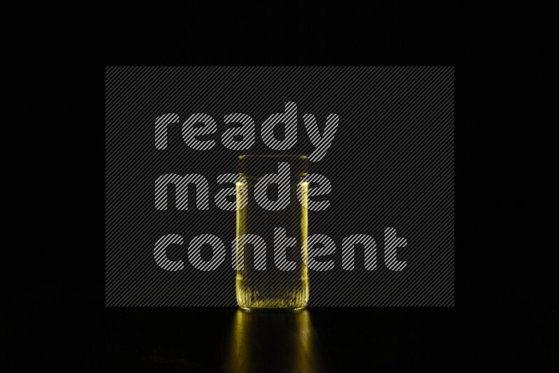 Glassware with rim light in yellow against black background