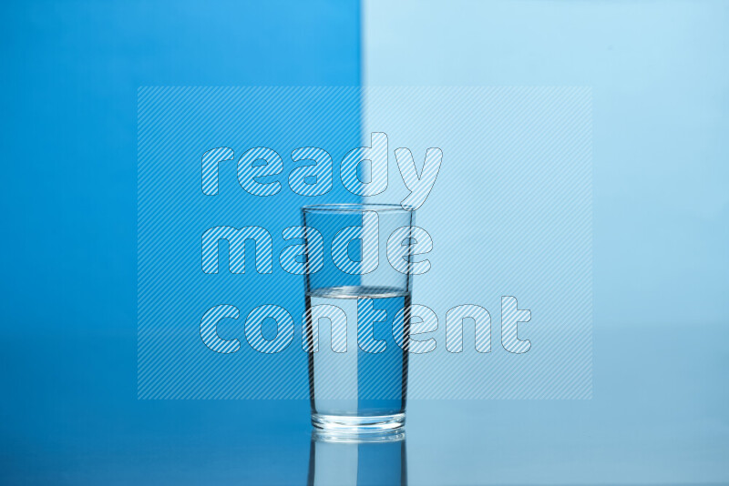 The image features a clear glassware filled with water, set against blue and light blue background