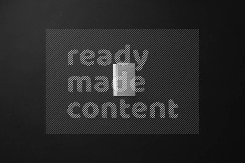 Folded notebook sheet on black background