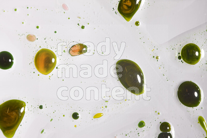 Close-ups of abstract yellow and green paint droplets on the surface