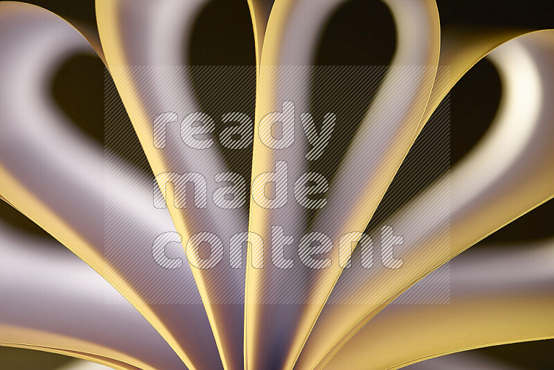 An abstract art piece displaying smooth curves in white and yellow gradients created by colored light