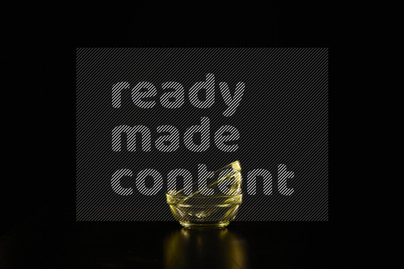 Glassware with rim light in yellow against black background