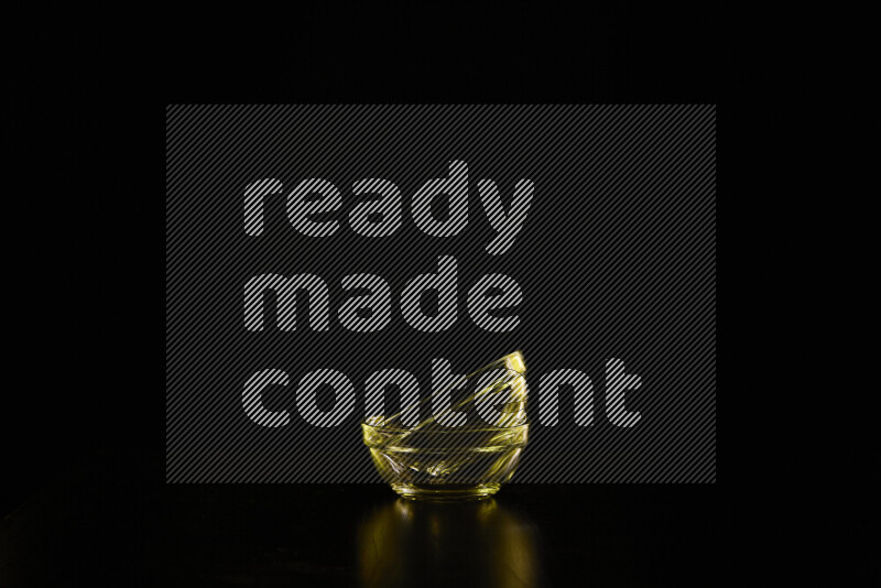 Glassware with rim light in yellow against black background