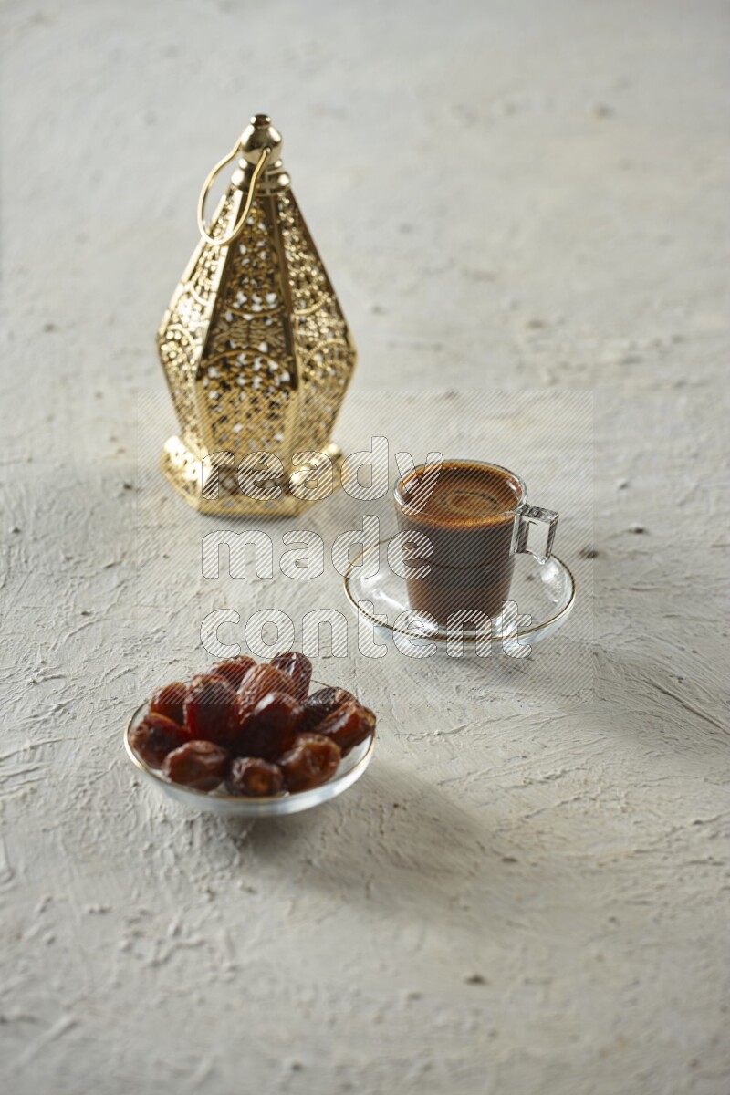 A golden lantern with different drinks, dates, nuts, prayer beads and quran on textured white background