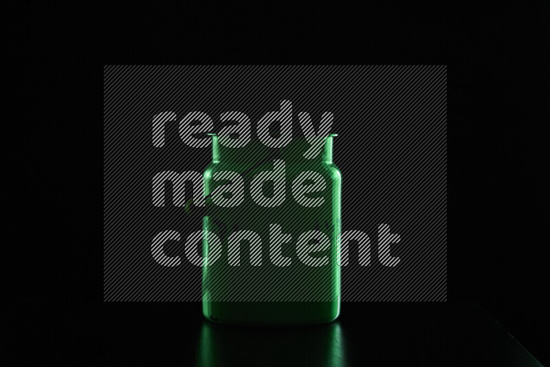 A vintage milk canister with colored rim light against black background