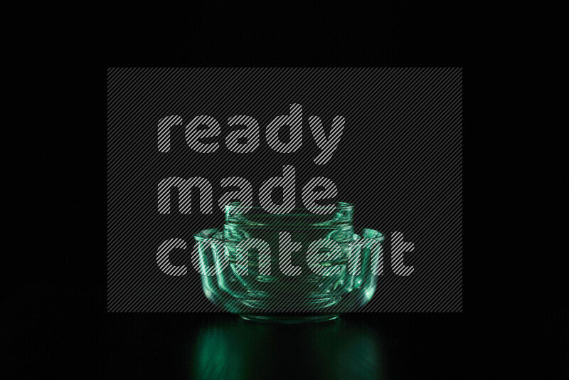 Glassware with rim light in green against black background