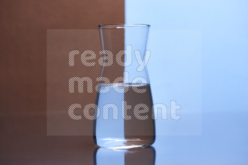 The image features a clear glassware filled with water, set against brown and light blue background