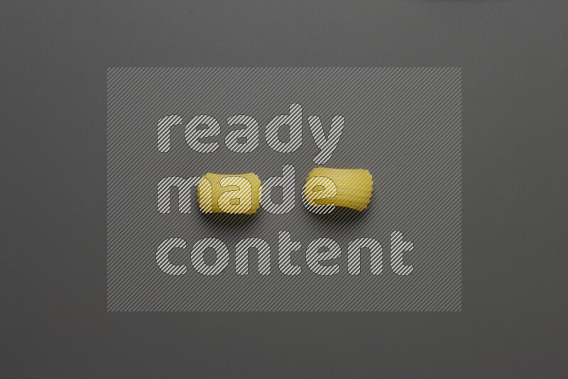 Elbow pasta on grey background
