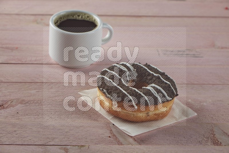 Chocolate crumbs doughnut on pink wooden background