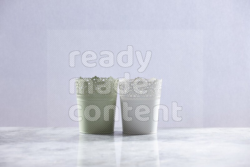Empty green and white plant pots on grey marble background