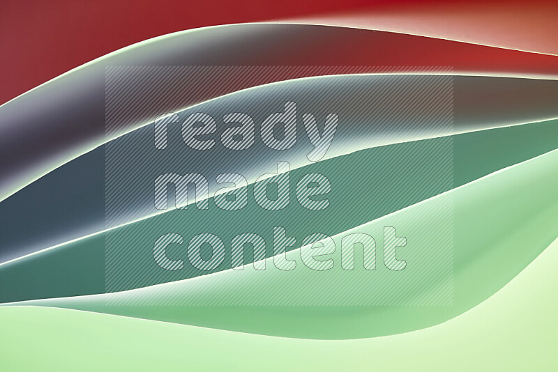 This image showcases an abstract paper art composition with paper curves in green and red gradients created by colored light