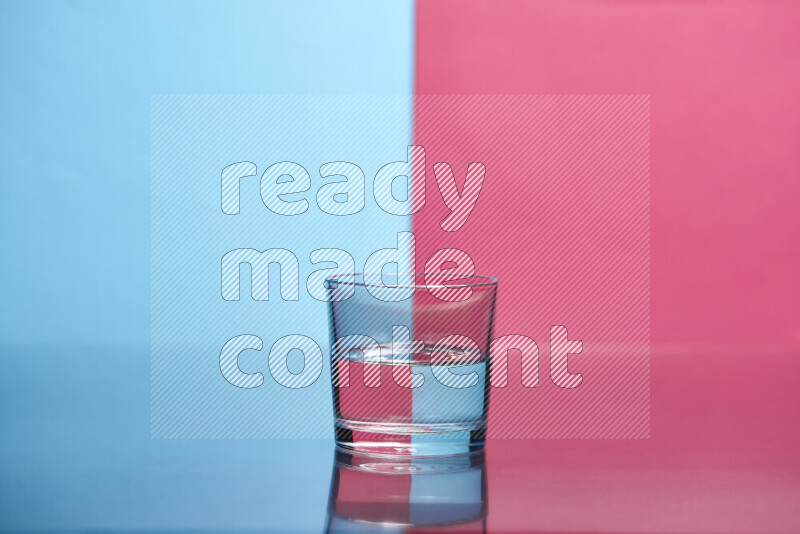 The image features a clear glassware filled with water, set against light blue and pink background