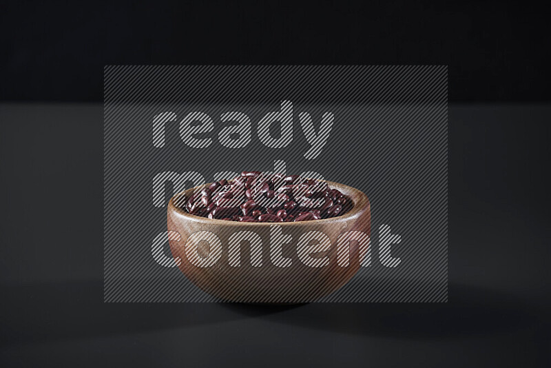 Red kidney beans in a wooden bowl on grey background