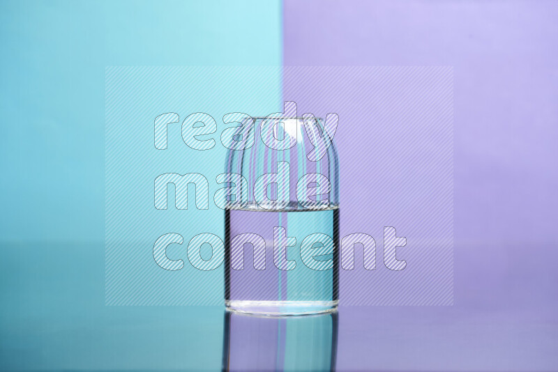 The image features a clear glassware filled with water, set against light blue and light purple background