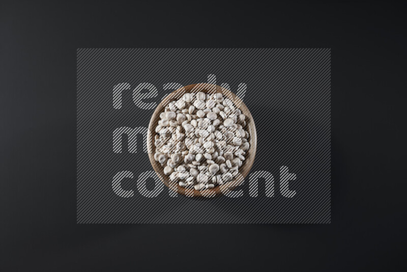 Lupin Beans in a wooden bowl on grey background