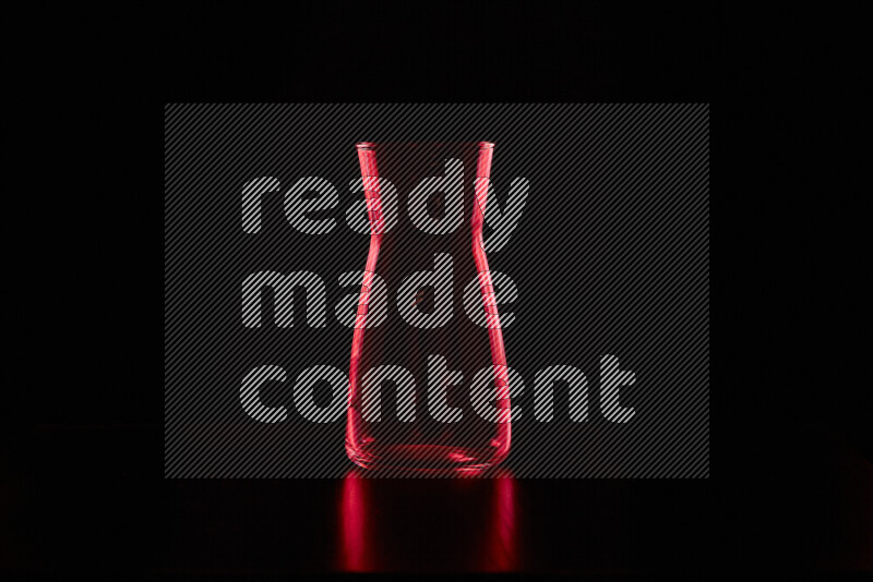 Glassware with rim light in red against black background