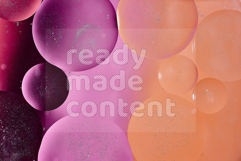 لقطات مقربة لفقاعات من الزيت على سطح الماء باللون الأحمر والبرتقالي والوردي