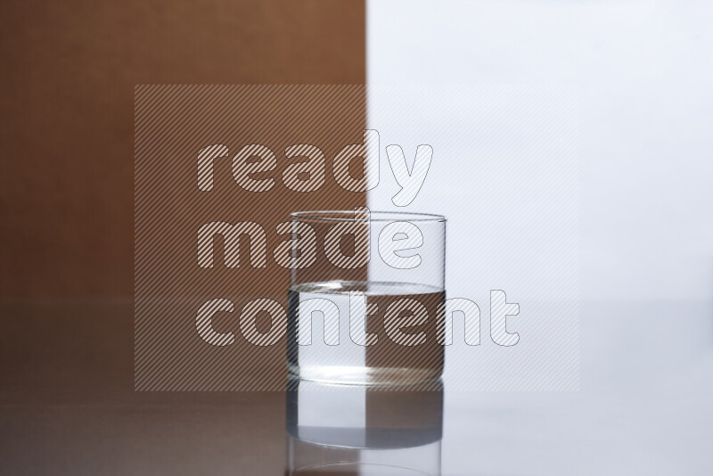 The image features a clear glassware filled with water, set against white and brown background