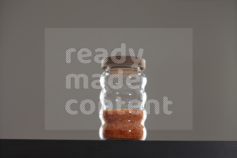 Lentils in a glass jar on black background