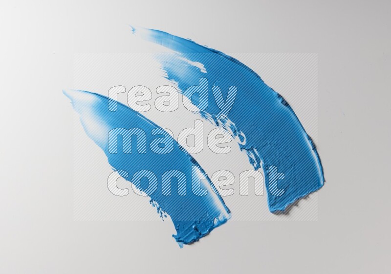 Blue curved painting knife strokes on white background