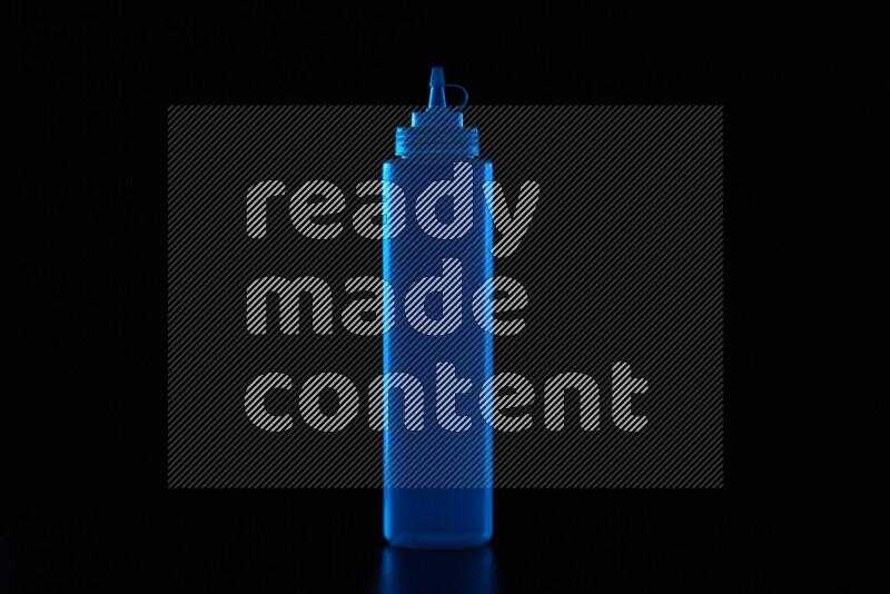 A squeeze bottle with colored rim light against black background