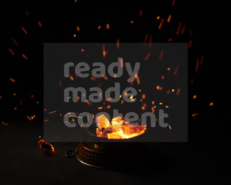 Coal cubes on fire in metal pan