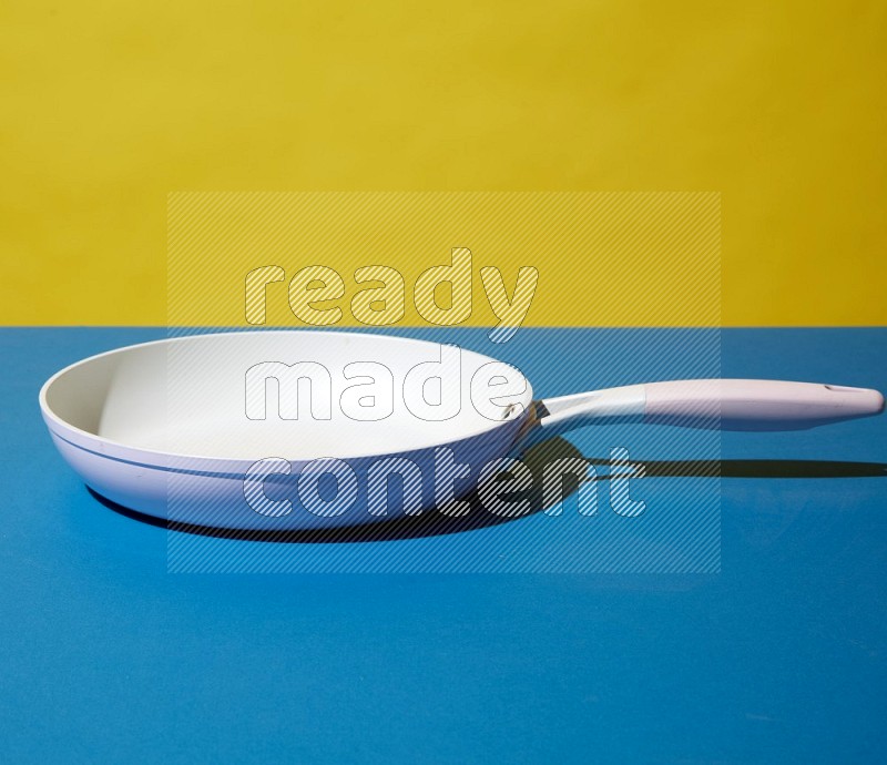 white pan on yellow and Blue background