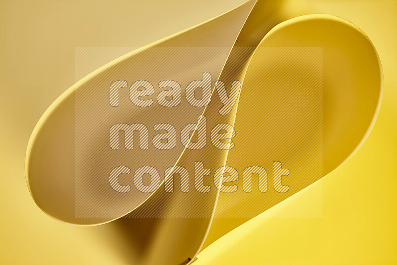 An abstract art of paper folded into smooth curves in yellow gradients