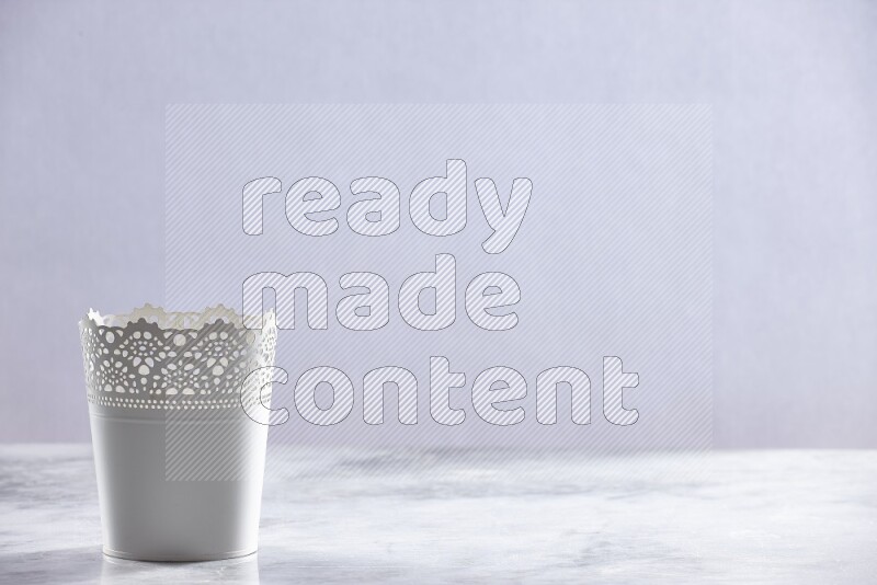 An empty white plant pot on grey marble background