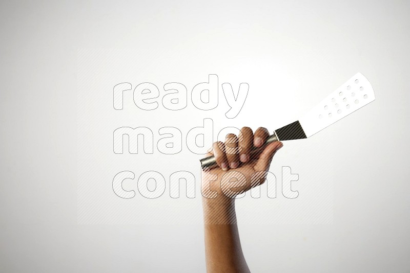 Male Hand Holding Burger Flipper on white background