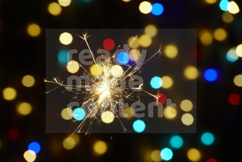 Sparkler candles with multicolored light bokeh background