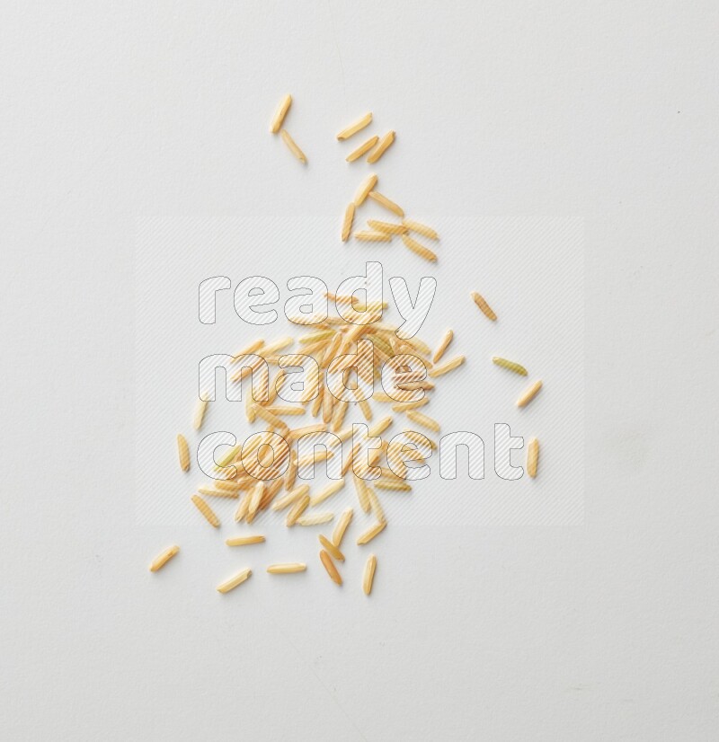 Top-view shot of long grain brown rice on white background