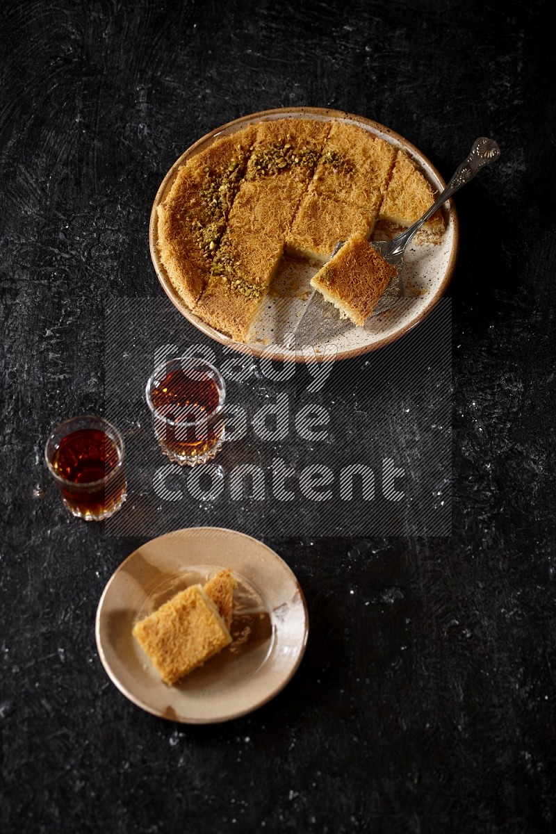 konafa with tea in a dark setup